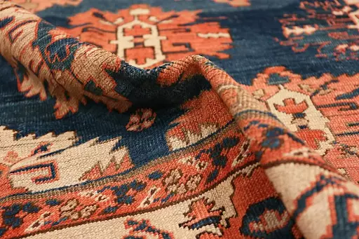 Antique blue background Persian Bakshaish rug. Image courtesy of Nazmiyal Auctions.