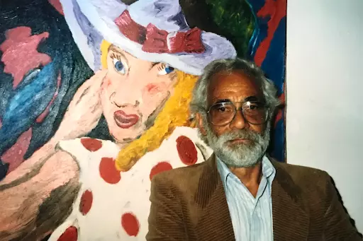 Robert Colescott with one of his paintings. Image by Barry Blinderman.