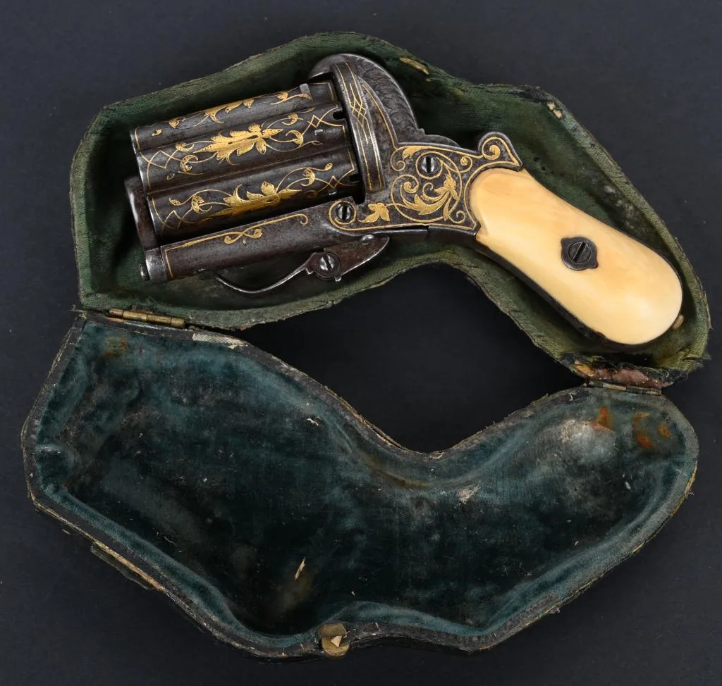 Circa-1860 gold-inlaid, bone-handled ‘knuckle duster,’ 1 7/8in caliber 7mm pinfire, six-shot barrel cluster, folding trigger and double-action operation. Housed in French fitted pipe case. Sold for $9,900 against an estimate of $2,500-$3,500