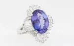 Lady's 14K White Gold Dinner Ring, with an oval 4.93 ct. tanzanite, atop a baguette and round diamond floret, total diamond wt.- 1.3 cts., Size 6 1/2,