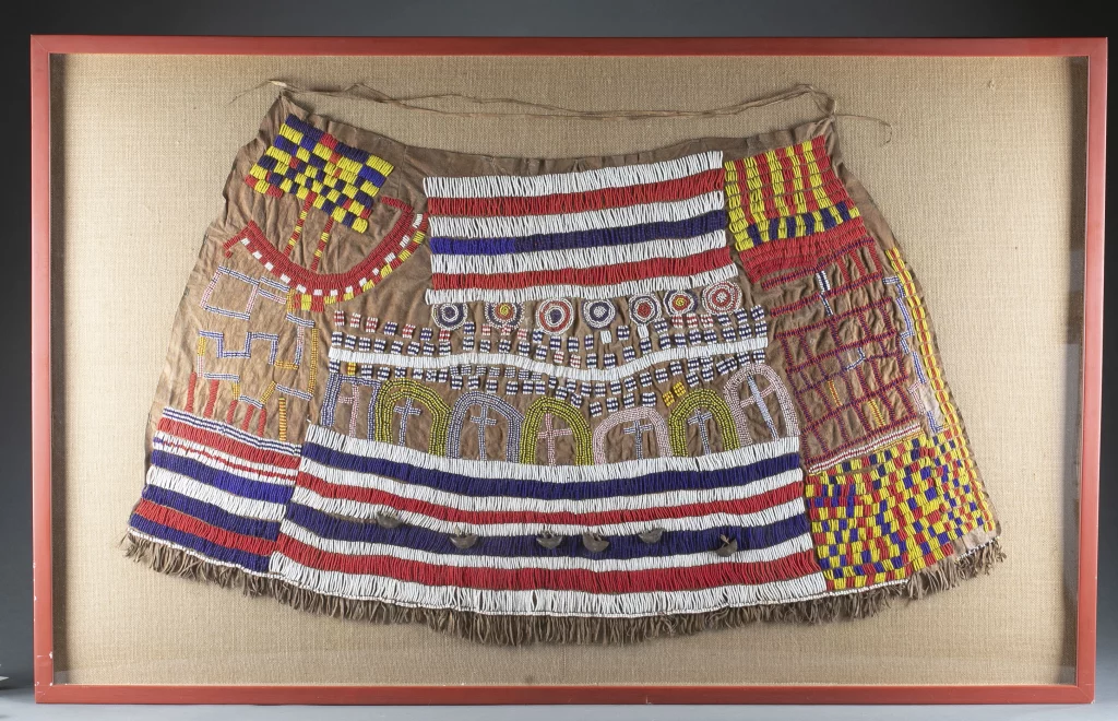 Iraqw beaded skirt, north-central Tanzania, East Africa, composed of animal hide with beads and natural fibers. Framed size: 61 5/8 x 38¾in (framed). Unique artwork. From the Estate of Dr. Giraud V. Foster, Baltimore, Maryland. Estimate $3,000-$5,000
