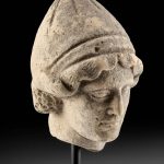 Greek Terracotta Head of a Youth Wearing Pilos Helmet
