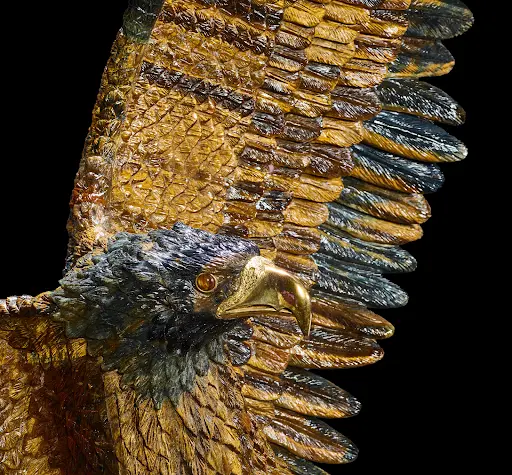 Detail of monumental tiger’s eye sculpture of an eagle on a marble base by Luis Alberto Quispe Aparicio, lot #3178. Image courtesy of Bonhams.