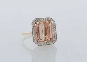 Lady's 14K Rose Gold Dinner Ring, with a 6.21 carat emerald cut morganite atop an octagonal border of small round diamonds, total diamond weight- .3 c