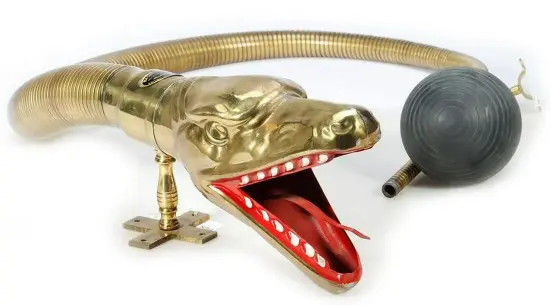 Snake Head with tongue, 5 to 6 foot tapering flexible tube, brackets, and squeeze bulb. Squeeze bulb has tear at base and tube from squeeze bulb is not connected to flexible tube fitting. Nameplate is present but glue has come loose. Estimate $800-$1,200. 