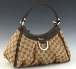 Gucci D-Ring Hobo, in beige and brown monogrammed canvas with brown leather accents and gold hardware, opening to a brown canvas lined interior with z