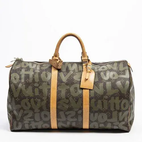 Louis Vuitton Limited Edition Stephen Sprouse Graffiti Keepall 50 Travel Bag, in monogram graffiti coated canvas with golden brass hardware, opening to a brown canvas interior, with Vachetta leather handles, accompanied by a Louis Vuitton dustbag, H.- 11 1/2 in., W.- 20 in., D.- 9 in.