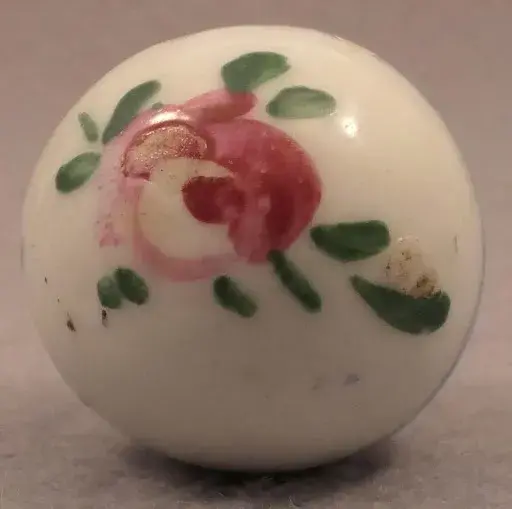 A white, hand-painted and glazed marble. Image courtesy of Block’s Marble Auctions, LLC.