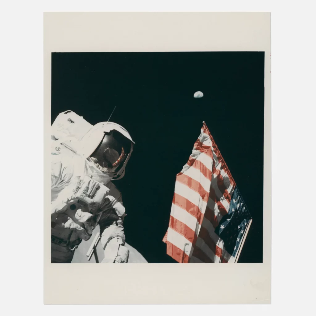 Harrison Schmitt, the Earth and the US flag, Eugene Cernan [Apollo 17], 7-19 December 1972, EVA 1  $4,000-6,000