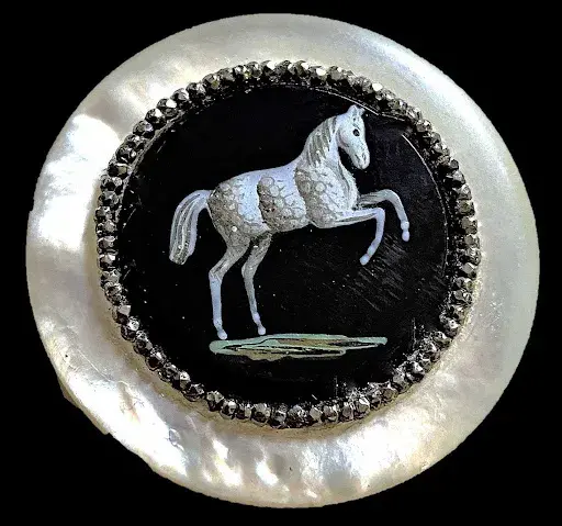 Lot #851, a pearl and black glass horse button. Image courtesy of Lion and Unicorn.