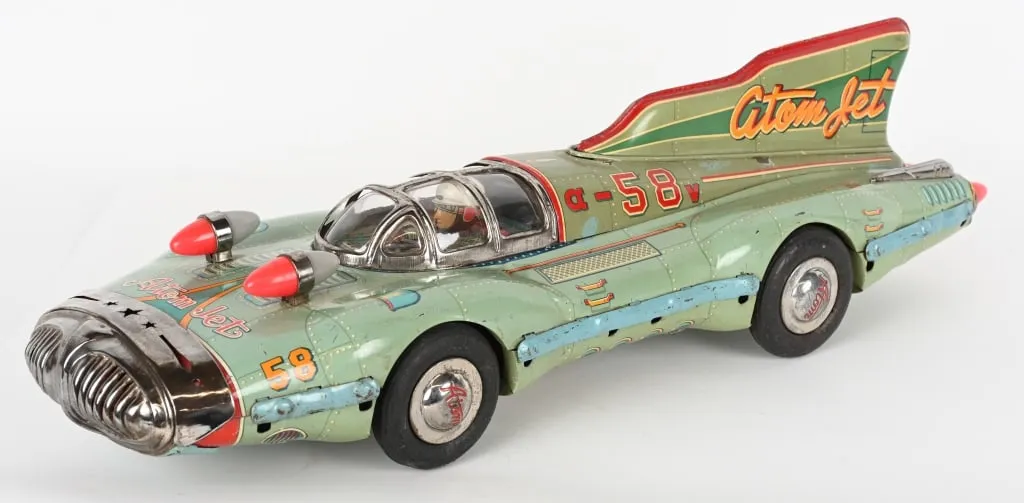 Large and wildly futuristic Yonezawa (Japan) tin friction #58 Atom Jet racer with driver inside clockwork. Beautiful colors, graphics and details. Both friction and motor sound are functional. Length: 26in. Estimate: $10,000-$15,000