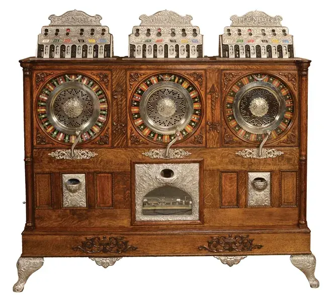 Extremely rare Caille Bros (Detroit) musical Triple Eclipse upright slot machine comprising three separate machines (5¢, 50¢, 5¢) in one stunning oak cabinet. Serial No. 121, the earliest of four extant examples of this model. Provenance includes Dobby Doc collection amassed in the 1930s/’40s and discovered in a Nevada warehouse in the late 1960s. Sold for $147,600