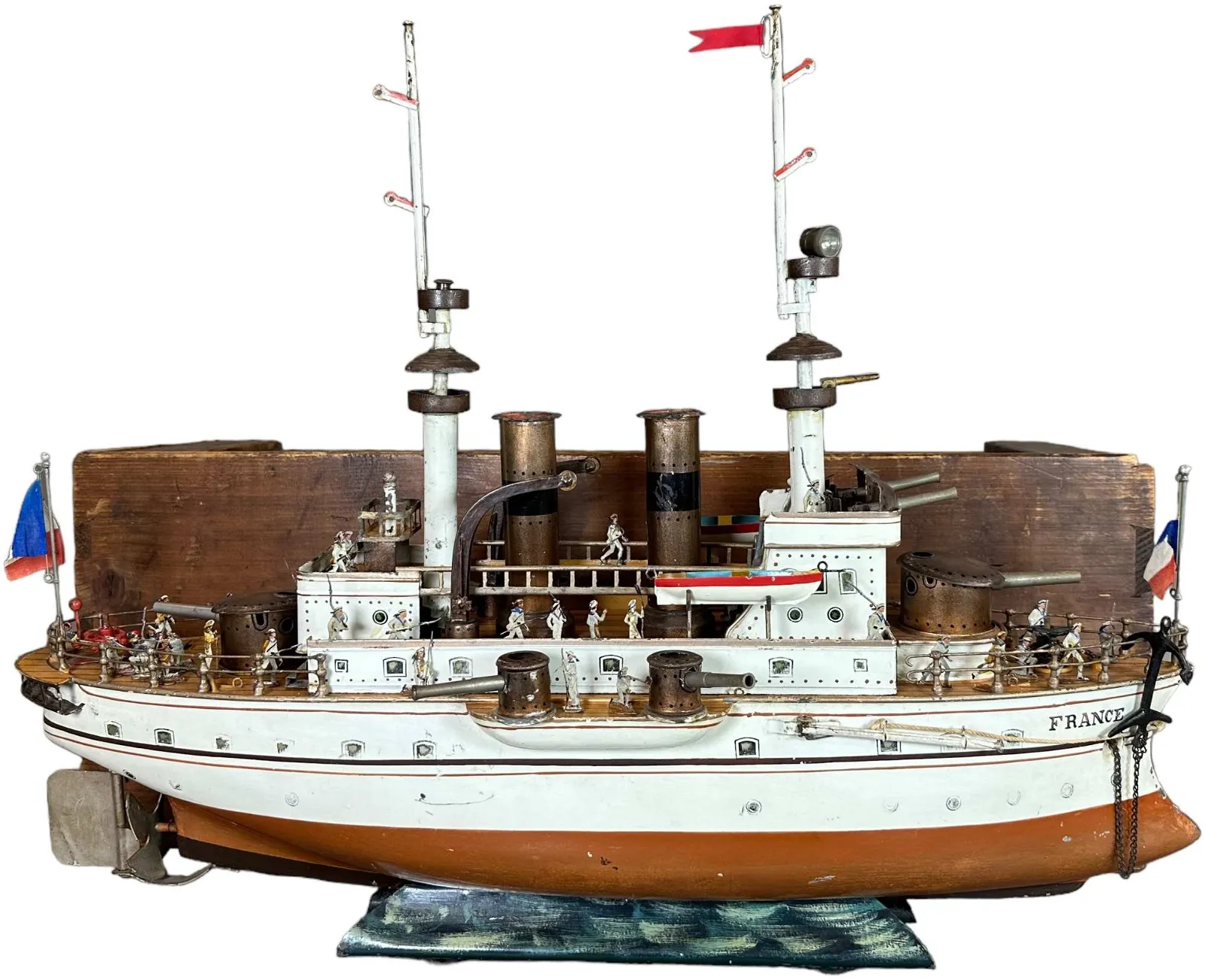 Marklin (Germany) clockwork ‘Battleship France,’ circa 1902-1907, with numerous cannons, lifeboats and masts. Retains original wood box/crate in which it was found together with (included) museum-quality lead sailor figures in like-new condition. Book example featured on Page 200 in David Pressland’s ‘Great Book of Tin Toys.’ Near-mint condition. Sold at upper end of estimate for $78,000