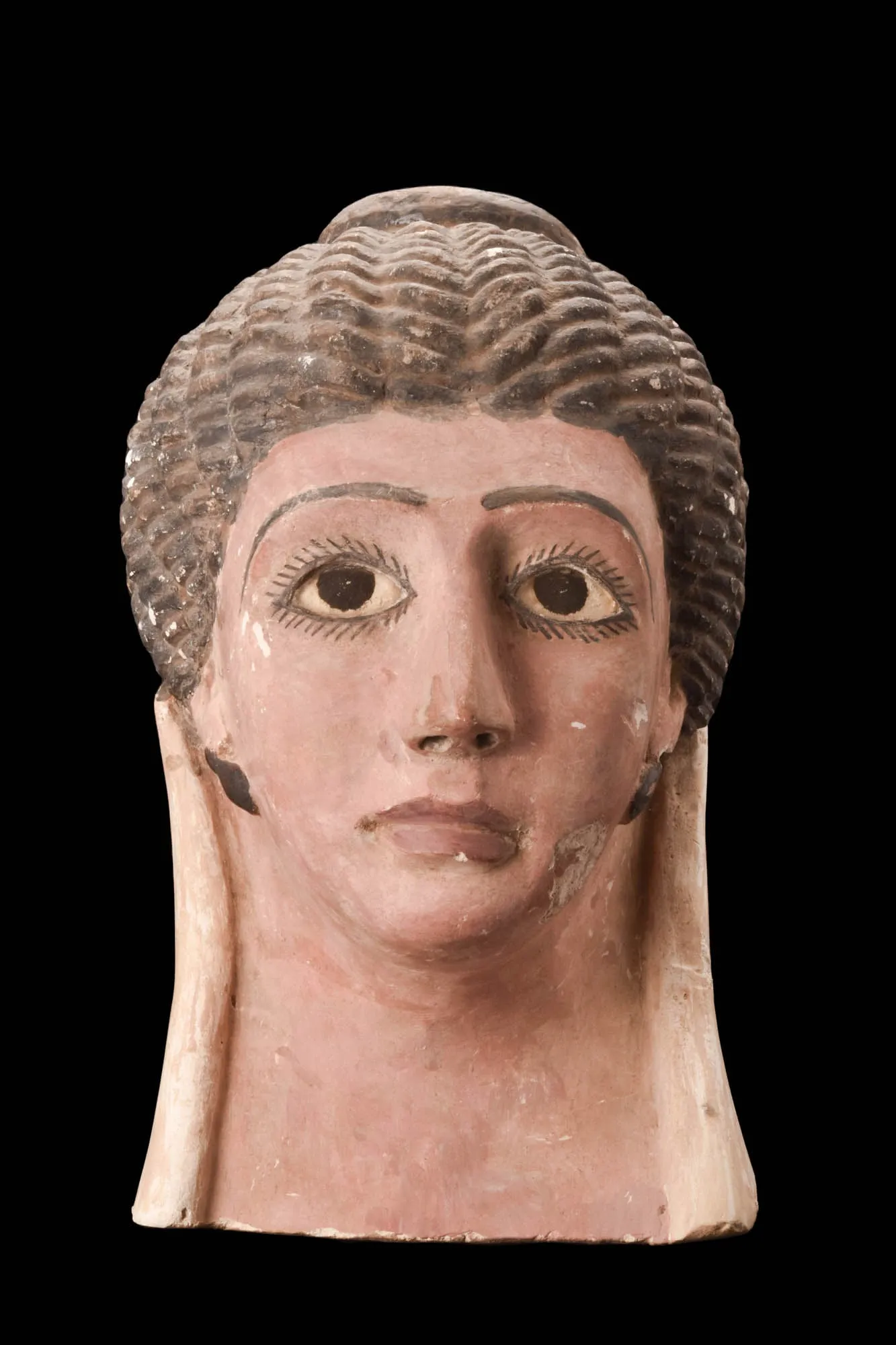 Circa 30 BC-323 AD Egyptian polychrome ceramic funerary mask of youthful female with braided hair and painted eyebrows, hair, lips, earrings and eyes, which have inset glass panels. Size: 275mm x 160mm (10.83in x 6.3in) Weight: 2.16kg (4lbs 12oz). Provenance: Property of an Israeli gentleman; acquired from Aaron Gallery, Berkeley Square, London W1 in 2011; formerly in the Issa collection, early 1980s. Opening bid: £5,000 ($6,400)