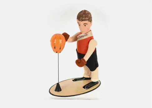 Schuco felt and tin windup Boxer Jack with platform and punching bag. Figure has painted facial features and wears original Schuco Germany imprinted fabric sash that says ‘Boxer-Champion.’ Height: 6in. All-original and in working order. Beautiful condition. Estimate: $2,000-$2,500