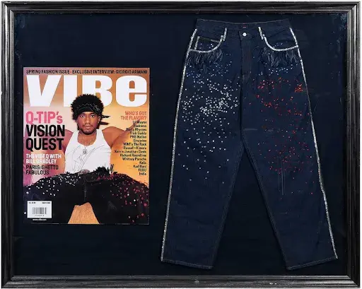 Framed Q-Tip-worn custom Tommy Hilfiger jeans with signed magazine cover. Image courtesy of Brunk Auctions. 
