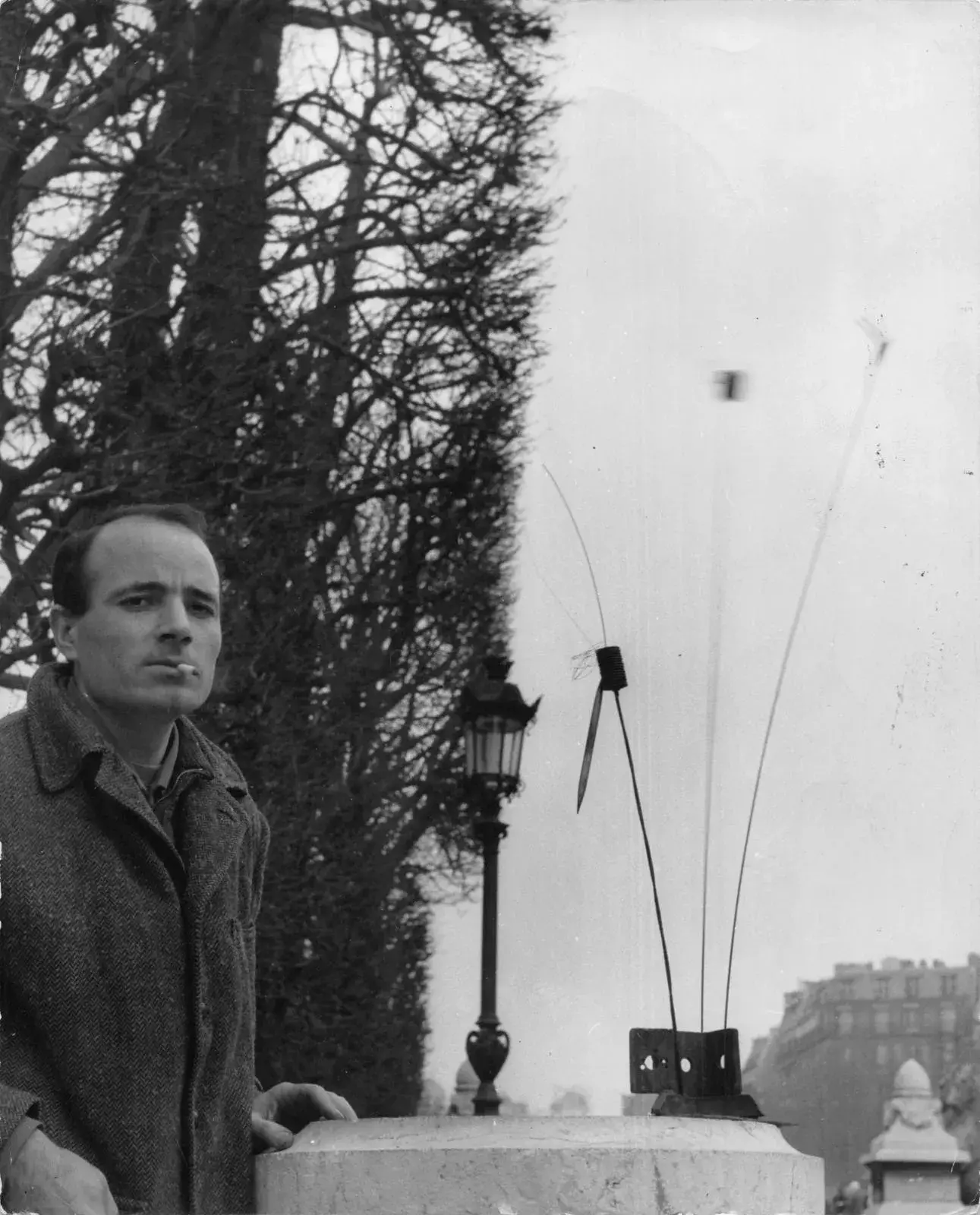 Takis in the Luxembourg Gardens in 1955, next to a Signal.
© PHOTO COURTESY OF MARTHA ROCHER ARCHIVE, ROME. ALL RIGHTS RESERVED